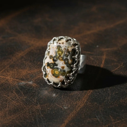 Custom Ocean Jasper ring with natural orbicular stone, sterling silver fleur-de-lis bezel and hammered band