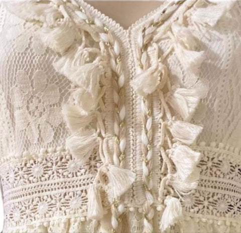 Front view of boho western summer midi dress with pom pom details

