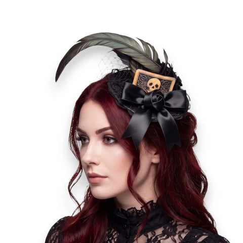 Black mini top hat fascinator with rooster feathers, lace, fishnet veil, satin bow and skull card detail