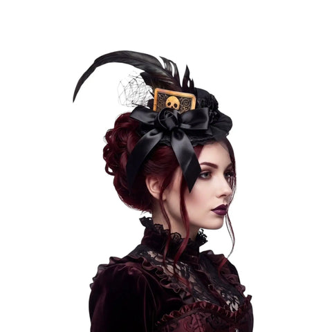 Black mini top hat fascinator with rooster feathers, lace, fishnet veil, satin bow and skull card detail