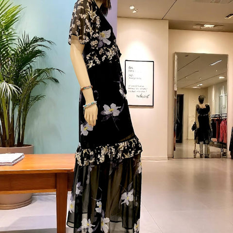 Black v-neck floral summer maxi dress with lace-up neckline, empire waist, and ruffle trim hem by Flying Tomato – boho chic fashion sideview