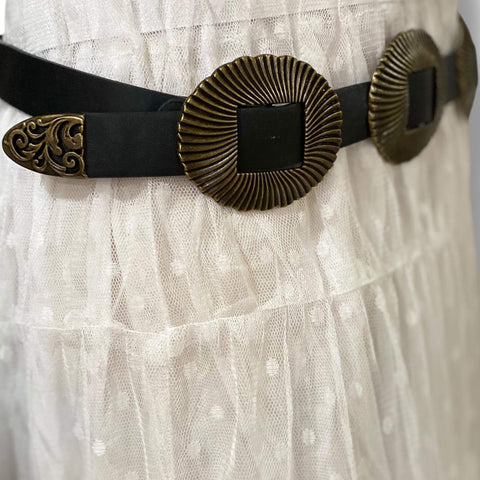 detail of ridged shell textured buckles antique gold finish filagree belt tip