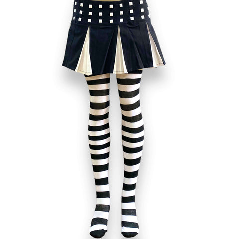 Studded Black & White Pleated Mini Skirt woman wearing with striped socks for punk Cyber Y2K vibe