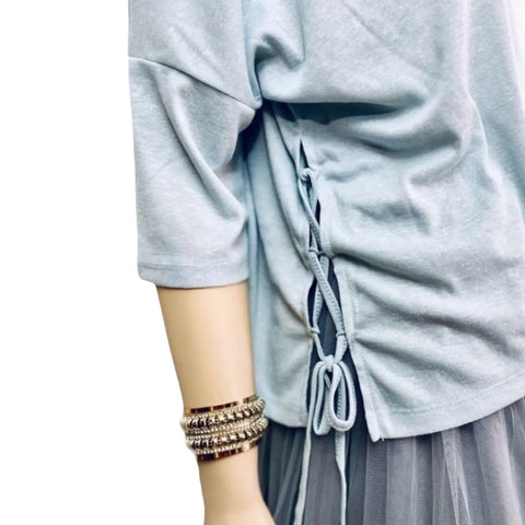 Blue wide boxy top with scoop neckline, dolman sleeves and adjustable lace-up side panels