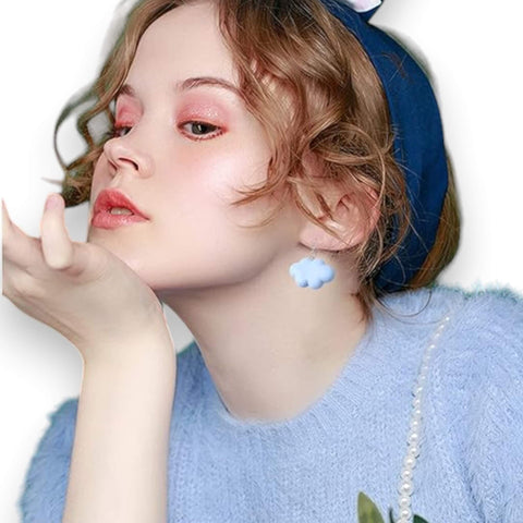 pastel blue cartoon cloud drop earrings on model 