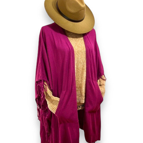 Women's boho fringe poncho with practical side pockets in merlot red