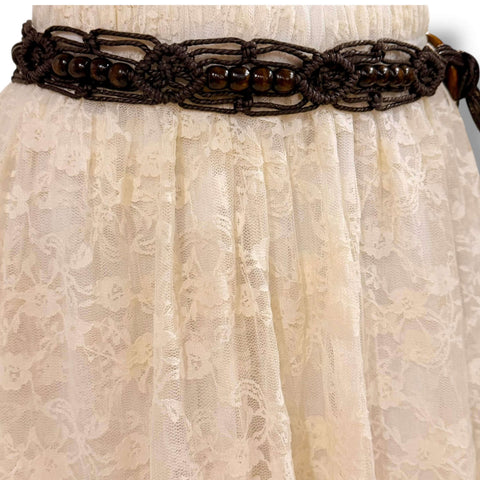 brown braided beaded tassel belt with wood ring buckle styled at the waist over a boho dress