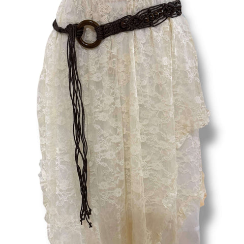 brown braided beaded tassel belt with wood ring buckle styled at the waist over a boho dress