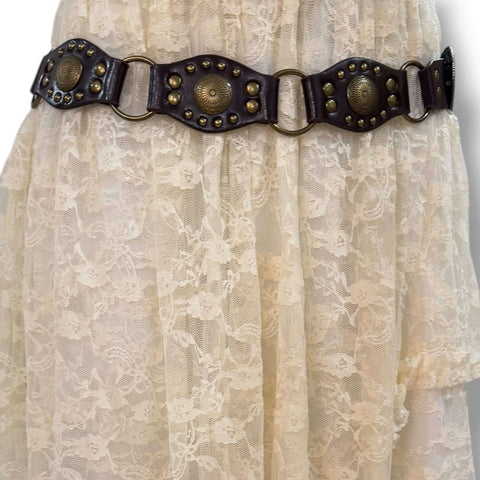 Western floral buckle medallion wide belt in brown or black vegan leather with antique gold studs rivets and O-rings, adjustable buckle closure, 1 3/8 inch strap width