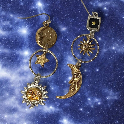 Cosmic sun moon star dangle earrings in silver and gold. Asymmetrical celestial charms with boho Y2K, witchy, gothic fashion influence. Lightweight drop earrings.