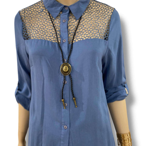 Western brass cowboy hat bolo tie with antique brass hat pendant, black braided leather rope, and silver-tipped ends styled for boho and western fashion.