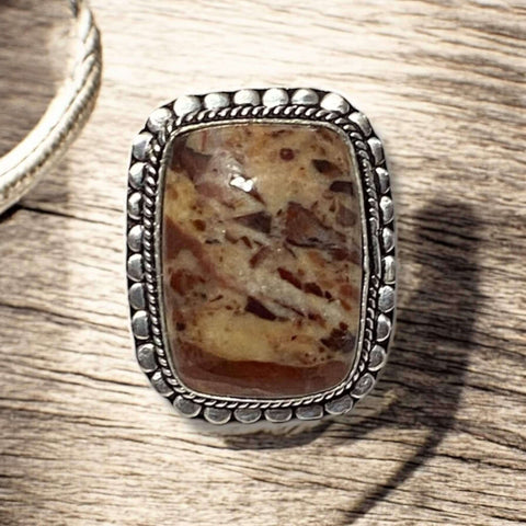 Close-up of Crazy Horse Jasper stone showing unique swirls and color patterns in handcrafted silver setting
