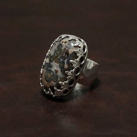 Custom Ocean Jasper ring with natural orbicular stone, sterling silver fleur-de-lis bezel and hammered band