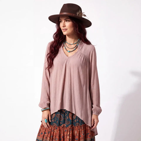 Woman wearing medium Mauve Ruffle V-Neck Long Sleeve Blouse with high-low hem and boho western style