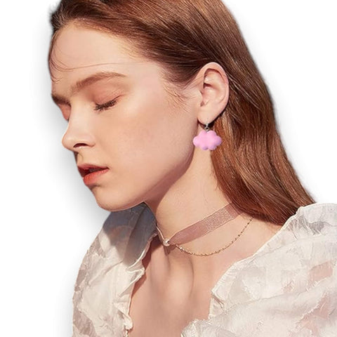 pastel pink cartoon cloud drop earrings on model 