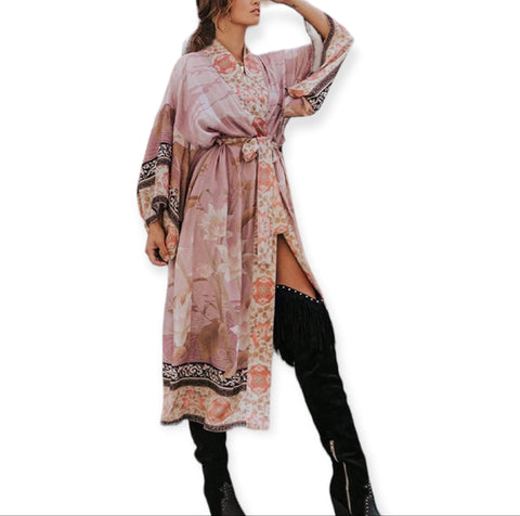 woman wearing pink flamingo print kimono beach cover up with floral design and sash with thigh high black suede heel boots