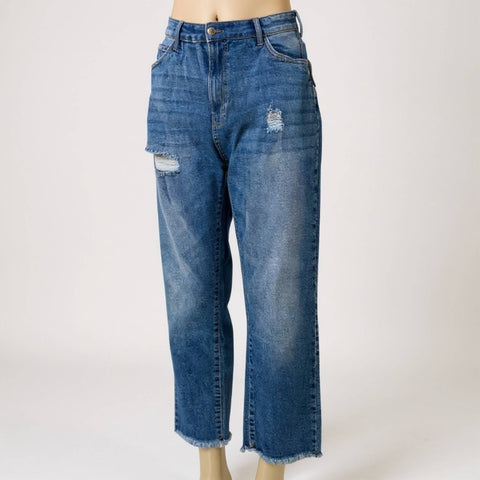 women wearing distressed details and frayed ankle hem close up denim jeans side view