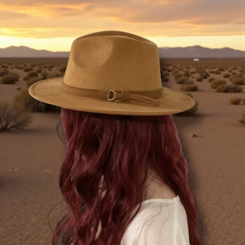 woman  wearing a brown  suede fedora hat in the desert 