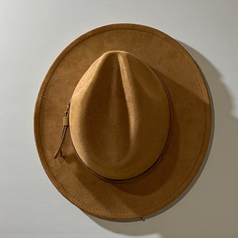 Brown suede fedora hat on a light gray background