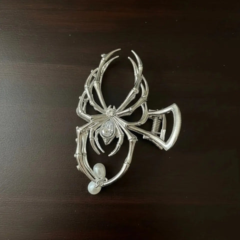 Silver Spider Metal Hair Clip with rhinestone spider body, dangling faux pearl drops and silver metal claw flat lay