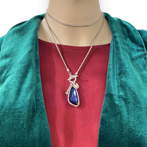 Silver talisman crystal pendant necklace with bold blue-purple faceted stone on silver toggle snake chain, mystical and adjustable statement jewelry piece.
