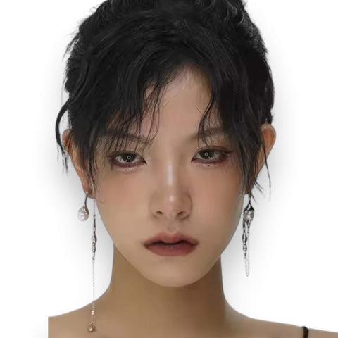 Silver asymmetrical pearl drop earrings with silver curb chains, simulated white pearls, and crystal accents, modern gothic and Y2K fashion jewelry.