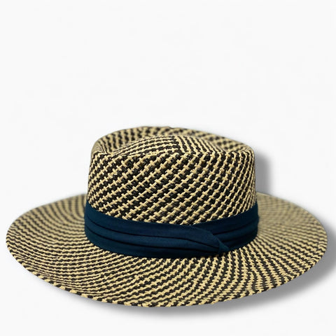 Woven straw hat with a navy band on a white background