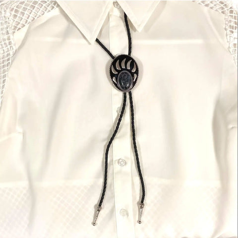 Two bear paw bolo ties with black braided leather cords: silver-tone faux turquoise bear claw slider and black stone bear paw pendant with antique metal tips.