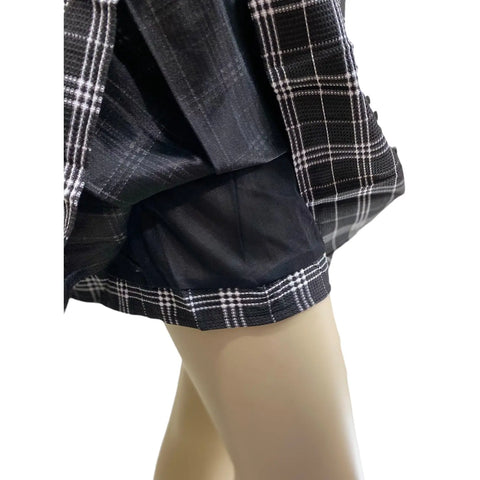 Back view of black and white plaid skirt with pleated hem – edgy casual outfit