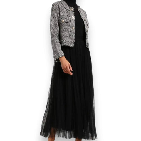 Woman wearing with formal attire Black Pleated Tulle Maxi Skirt with layered mesh, A-line silhouette, stretch waistband, and opaque lining