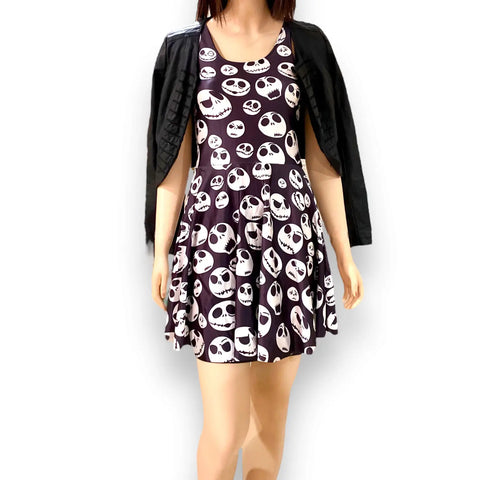 Black sleeveless mini dress with white skull print, round neckline, and fit & flare silhouette. Edgy punk and whimsygoth summer style.