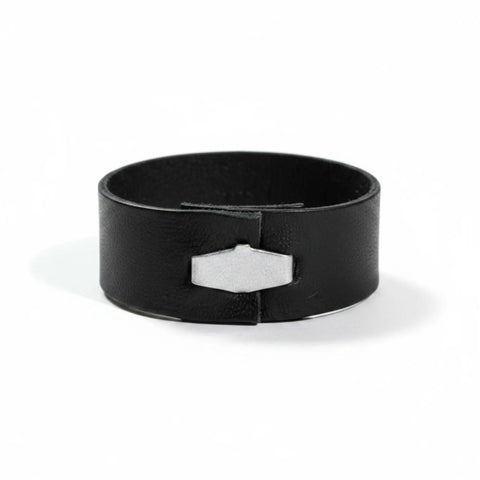 Black leather band rings set with silver geometric hardware and five assorted stackable ring sizes