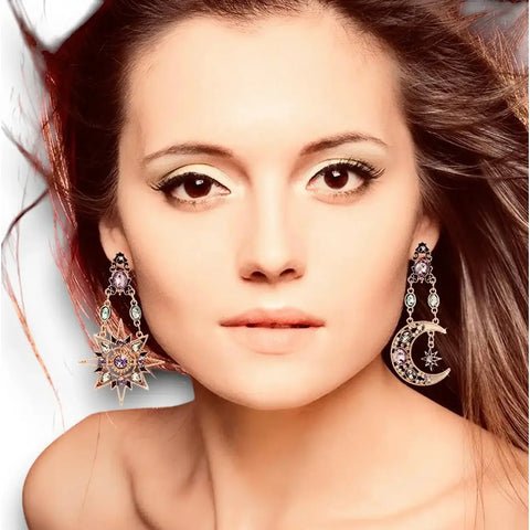 woman wearing pair of Celestial Gold Stars Moons Hanging Earrings with multicolored crystals, faux pearls, asymmetrical drop statement earrings 