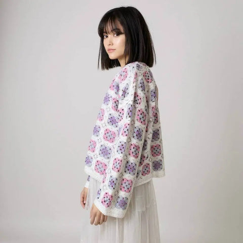 women wearing wide sleeve crochet cardigan pastel pink purple blue side view