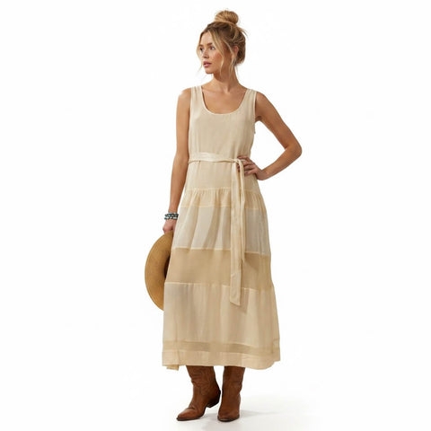 woman wearing Free People cream sleeveless tiered panel maxi dress with scoop neckline and waist tie