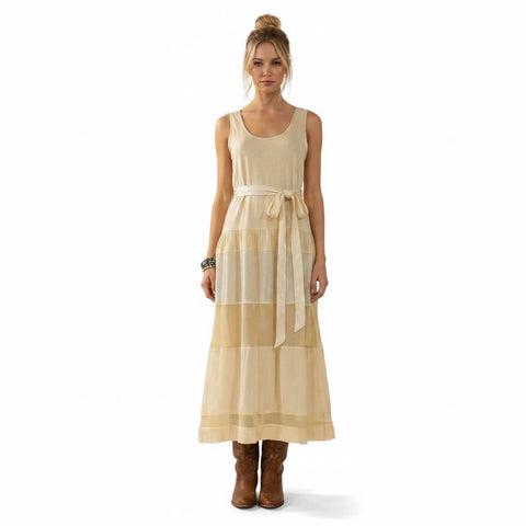 woman wearing Free People cream sleeveless tiered panel maxi dress with scoop neckline and waist tie