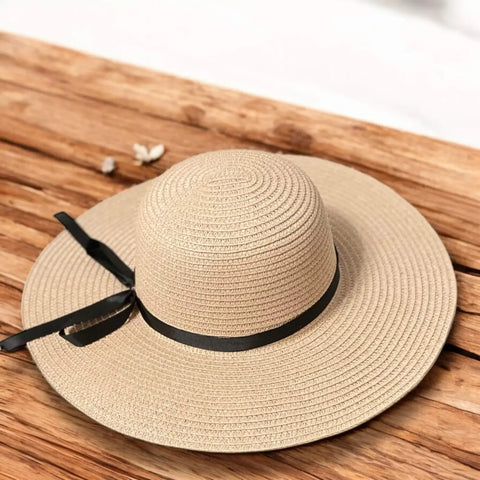 Floppy wide brim straw sun hat with black ribbon band, sustainable braided straw, boho chic summer fashion.