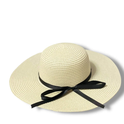 Floppy wide brim straw sun hat with black ribbon band, sustainable braided straw, boho chic summer fashion.
