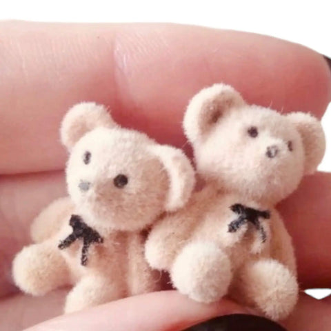 Fuzzy Teddy Bears Post Earrings featuring cute teddy bear designs with tiny bow ties in a person's hand.