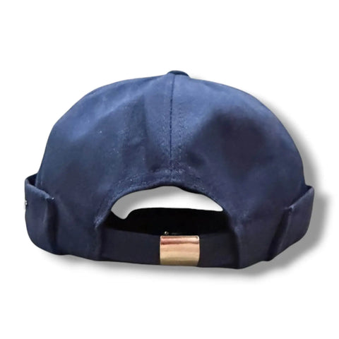 flat lay Harbour Cotton Docker No Brim Cap in navy blue rolled edge, eyelets, button top, and adjustable strap osfm / unisex