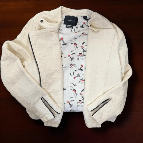 Ivory Textured Biker Jacket with black zipper accents, asymmetric moto front, snap collar, and palm print lining – edgy women's mid weight cotton jacket. 