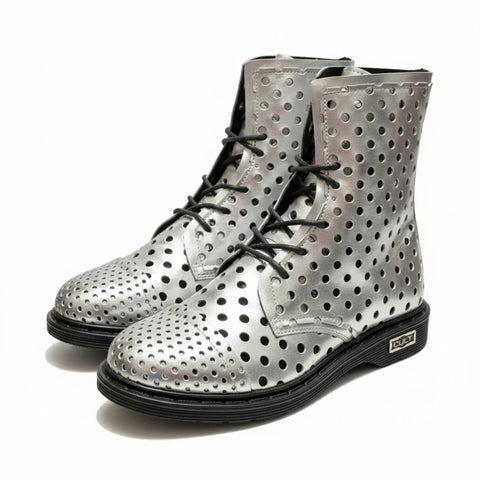 Side profile of the Cult Metallic Sabbath Leather boots highlighting the reflective silver upper, geometric cutouts, 7-inch shaft, and 1-inch heel.