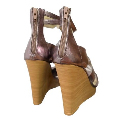 Metallic pink strappy open toe wedge sandals with ankle buckle and back zipper. back view