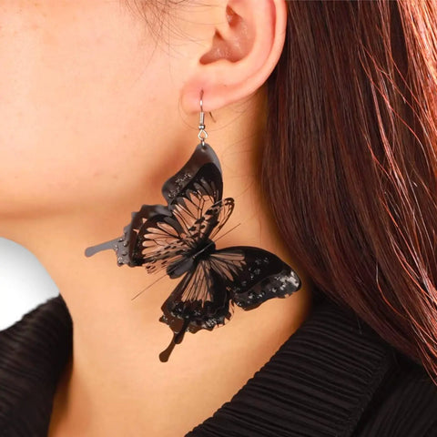 Oversized black butterfly dangling earrings with 3D layered wings in black and clear plastic – statement fairycore and Halloween jewelry

