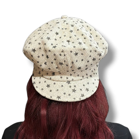 woman wearing backwards Oversized Newsboy Big Volume Hat in ivory textured knit with faded black stars, slouchy crown, and soft brim