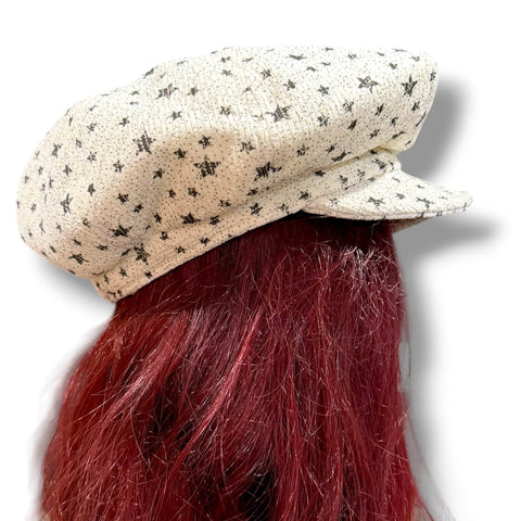 side view of Oversized Newsboy Big Volume Hat in ivory textured knit with faded black stars, slouchy crown, and soft brim