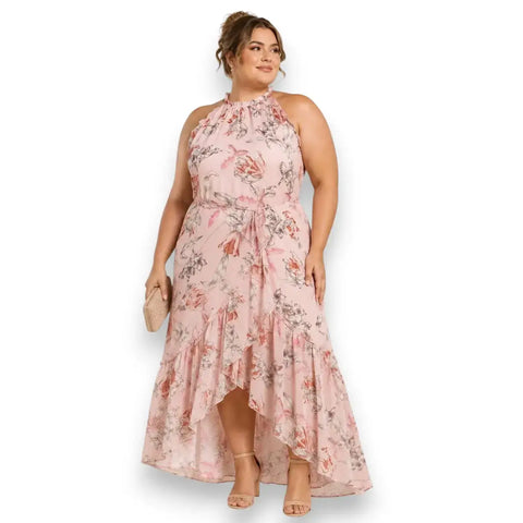 woman wearing Plus Pink Sleeveless Floral Ruffle Midi Dress with frill mock neckline, waist tie, high-low tulip hem, and full lining