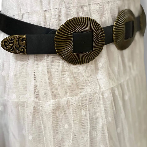 detail of ridged shell textured buckles antique gold finish filagree belt tip