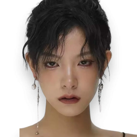 Silver asymmetrical pearl drop earrings with silver curb chains, simulated white pearls, and crystal accents, modern gothic and Y2K fashion jewelry.