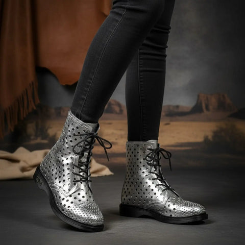 Silver Cut Out Mid Calf Boots by Cult featuring leather laminated metallic finish, round geometric perforations, contrasting black laces, and a branded rubber outsole. Women's Size 7, EU 37.
